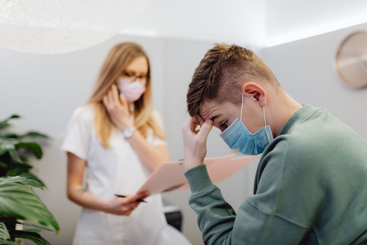 Woman at doctor receiving worrying lab results, face showing concern